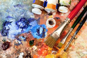 Artistic equipment: paint, brushes, spatula and art palette